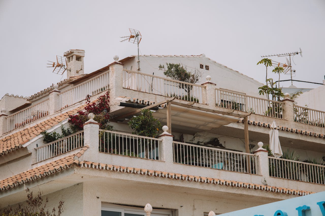 A serene view of a classic Spanish rooftop terrace with plants in Málaga, Spain.