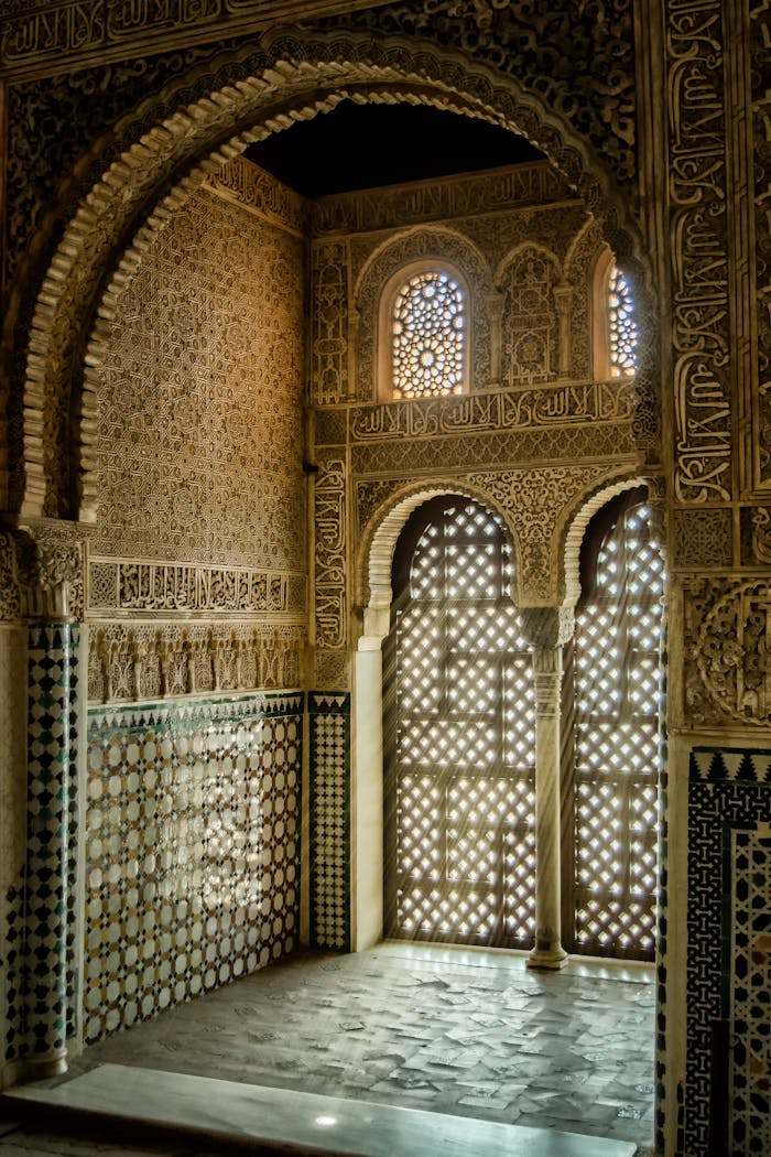 Stunning Moorish architectural design inside the Alhambra with intricate mosaic and stone work.