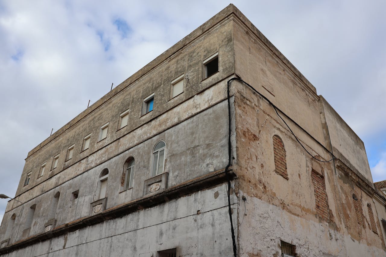 Explore the weathered facade of an old building in Puerto Real, Andalucía.