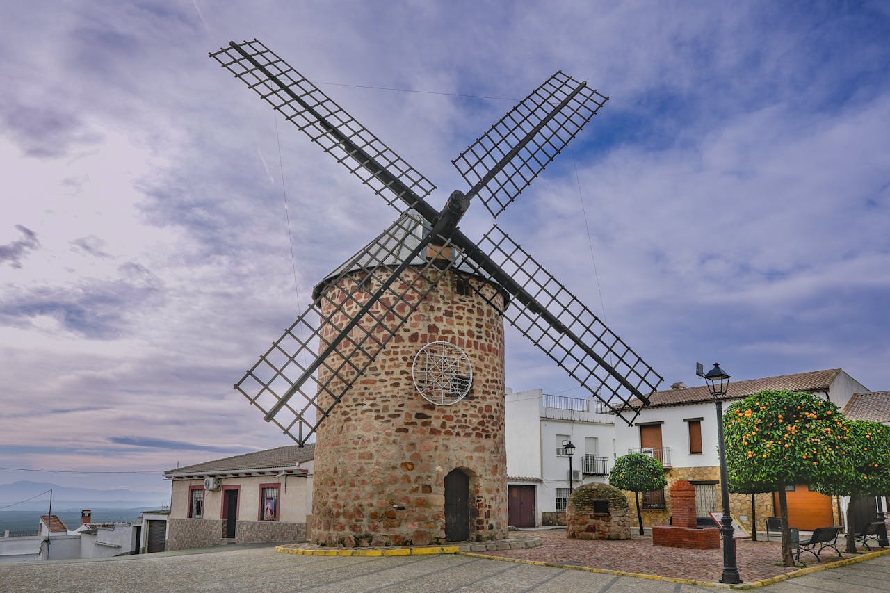 Beautiful old windmill in Baños de la Encina, Andalucía, surrounded by charming village scenery.