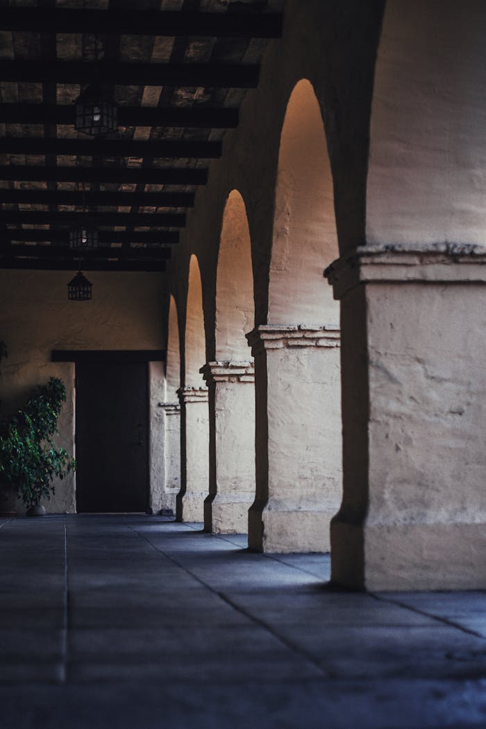 A beautifully preserved arched corridor at Old Mission Santa Ines, showcasing classic architectural design.